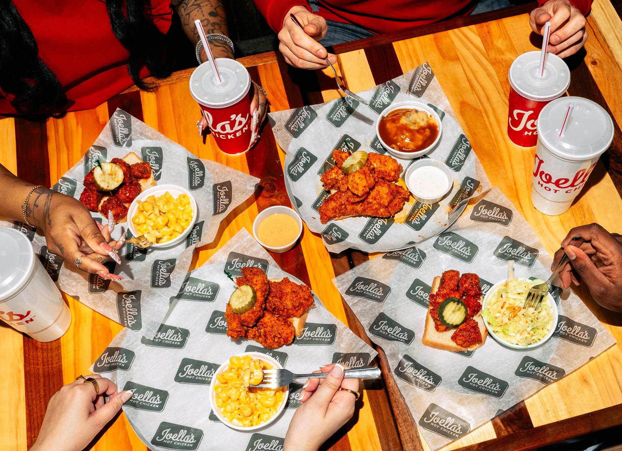 Joella's table overhead, hands reaching for food